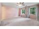 Bright bedroom featuring carpeted floors, calming walls, and light blue curtains framing the windows at 8255 Habersham Waters Rd, Atlanta, GA 30350