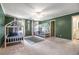 Charming bedroom featuring two twin beds, carpeted floors, and calming green walls at 8255 Habersham Waters Rd, Atlanta, GA 30350