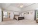 Large bedroom with tray ceiling, plush carpet, and neutral decor, creating a relaxing retreat at 8255 Habersham Waters Rd, Atlanta, GA 30350