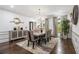 Dining room with modern decor, stylish chandelier, and a large window bringing in natural light at 8255 Habersham Waters Rd, Atlanta, GA 30350