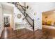 Elegant foyer with hardwood floors, staircase, and stylish decor creating a welcoming entrance at 8255 Habersham Waters Rd, Atlanta, GA 30350