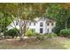 Stately home exterior with a lush front yard and mature trees enhancing curb appeal at 8255 Habersham Waters Rd, Atlanta, GA 30350