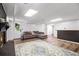 Bright basement living room featuring a dark brick fireplace, carpeted floors, and a cozy sofa at 8255 Habersham Waters Rd, Atlanta, GA 30350