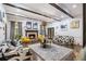 Spacious living room featuring a fireplace, stylish sofas, and decorative ceiling beams at 8255 Habersham Waters Rd, Atlanta, GA 30350