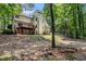 Rear exterior showcasing the multiple levels and an expansive wooded backyard at 8255 Habersham Waters Rd, Atlanta, GA 30350