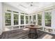 Sunroom with floor-to-ceiling windows providing natural light and scenic views of the surrounding landscape at 8255 Habersham Waters Rd, Atlanta, GA 30350