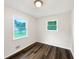 Bright bedroom with hardwood floors and two windows offering natural light at 145 Washington St, Mcdonough, GA 30253