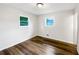 Bright bedroom with light-colored walls, wood floors, and natural light from two windows at 145 Washington St, Mcdonough, GA 30253