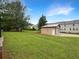 Spacious detached two-car garage with ample yard space, perfect for storage or workshop at 145 Washington St, Mcdonough, GA 30253