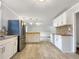 Open kitchen concept with stainless appliances, tile floors, and ample storage at 145 Washington St, Mcdonough, GA 30253