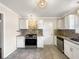Updated kitchen featuring stainless steel appliances, white cabinets, and stylish backsplash at 145 Washington St, Mcdonough, GA 30253