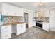 Bright kitchen features tile backsplash, wood countertops, and modern appliances at 145 Washington St, Mcdonough, GA 30253