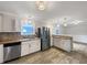 Modern kitchen with stainless steel appliances, tile backsplash, and wood counters at 145 Washington St, Mcdonough, GA 30253
