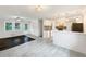 Bright living room featuring hardwood accent, modern lighting, and tile flooring at 145 Washington St, Mcdonough, GA 30253