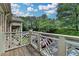 Home featuring an outdoor balcony with a wood floor and white railing with a view of trees at 3650 Ashford Dunwoody Rd, Ne, #923 # 923, Atlanta, GA 30319