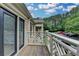View from a home's balcony featuring a decorative railing, with a brick wall and exterior door at 3650 Ashford Dunwoody Rd, Ne, #923 # 923, Atlanta, GA 30319