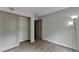 Bright bedroom with a closet, doorway, hardwood floor and modern lighting at 3650 Ashford Dunwoody Rd, Ne, #923 # 923, Atlanta, GA 30319