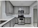 Kitchen featuring stainless steel appliances, stone countertops, and light gray cabinets at 3650 Ashford Dunwoody Rd, Ne, #923 # 923, Atlanta, GA 30319