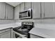 Kitchen featuring stainless steel appliances, stone countertops, and light gray cabinets at 3650 Ashford Dunwoody Rd, Ne, #923 # 923, Atlanta, GA 30319