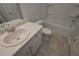 This bathroom features a white vanity, a toilet, and a shower and bathtub combo at 490 Charleston Pl, Villa Rica, GA 30180