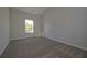 A well-lit bedroom features neutral walls, carpet flooring and a view of the outdoors at 490 Charleston Pl, Villa Rica, GA 30180