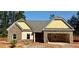 Charming single-story home featuring stone accents, a welcoming front porch, and an attached two-car garage at 490 Charleston Pl, Villa Rica, GA 30180
