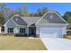 Charming one-story home boasts a two-car garage, stone accents, complemented by a well-manicured lawn at 490 Charleston Pl, Villa Rica, GA 30180