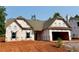 New construction featuring a gabled roof, black trimmed windows, and a spacious two car garage at 490 Charleston Pl, Villa Rica, GA 30180