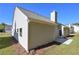 Image showcasing the home's light siding, chimney, and well maintained landscape at 490 Charleston Pl, Villa Rica, GA 30180