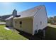 Image showcasing the home's light siding, chimney, and well maintained landscape at 490 Charleston Pl, Villa Rica, GA 30180