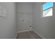 Compact laundry room with hookups and shelving ready for organizing household tasks at 490 Charleston Pl, Villa Rica, GA 30180
