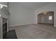 Bright, carpeted living room featuring a fireplace and arched entryway at 490 Charleston Pl, Villa Rica, GA 30180