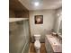 Compact bathroom with a glass-enclosed shower, tiled walls, and a vanity with a granite countertop at 976 Bakers Bridge Rd, Douglasville, GA 30134