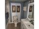 Bathroom with shower and tub combination, decorated with artwork, neutral tiles, and modern fixtures at 976 Bakers Bridge Rd, Douglasville, GA 30134