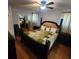 Bedroom features a four-poster bed, wood floors, two bedside tables and a ceiling fan at 976 Bakers Bridge Rd, Douglasville, GA 30134
