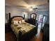 Bedroom features a four-poster bed, wood floors, dresser and a ceiling fan at 976 Bakers Bridge Rd, Douglasville, GA 30134
