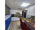 Kitchen featuring stainless steel appliances, granite countertop, tiled flooring, and decorative place settings at 976 Bakers Bridge Rd, Douglasville, GA 30134