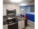 Kitchen offering stainless steel appliances, white cabinets, an eat in area, and tiled floor at 976 Bakers Bridge Rd, Douglasville, GA 30134