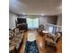 Inviting living room featuring hardwood floors, cozy seating, and a charming fireplace at 976 Bakers Bridge Rd, Douglasville, GA 30134
