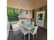 Covered patio with dining table and seating area provides a perfect outdoor retreat with nature views at 976 Bakers Bridge Rd, Douglasville, GA 30134