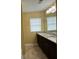 Bathroom with a long dark vanity, single sink, and tile floor at 102 Daisy Cir, Mcdonough, GA 30252