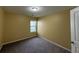 Carpeted secondary bedroom with a large window offering lots of natural light at 102 Daisy Cir, Mcdonough, GA 30252