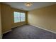 Neutral bedroom featuring carpet flooring and a bright window view at 102 Daisy Cir, Mcdonough, GA 30252