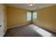 Comfortable secondary bedroom with two windows and plush carpet at 102 Daisy Cir, Mcdonough, GA 30252