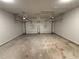 Spacious two-car garage with dual automatic doors and an unfinished floor at 102 Daisy Cir, Mcdonough, GA 30252