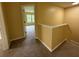 Hallway leading to a room with neutral colored walls and plush carpets at 102 Daisy Cir, Mcdonough, GA 30252