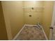 Small, functional laundry room with a tile floor and shelving unit at 102 Daisy Cir, Mcdonough, GA 30252