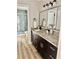 Modern bathroom with granite countertops, dark wood cabinetry, and a tiled shower at 112 Village Ct, Woodstock, GA 30188