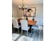 Elegant dining room featuring a solid wood table, chandelier, and stylish seating for six at 112 Village Ct, Woodstock, GA 30188