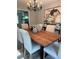 Chic dining room with wooden table, chandelier lighting, and modern decor accents at 112 Village Ct, Woodstock, GA 30188